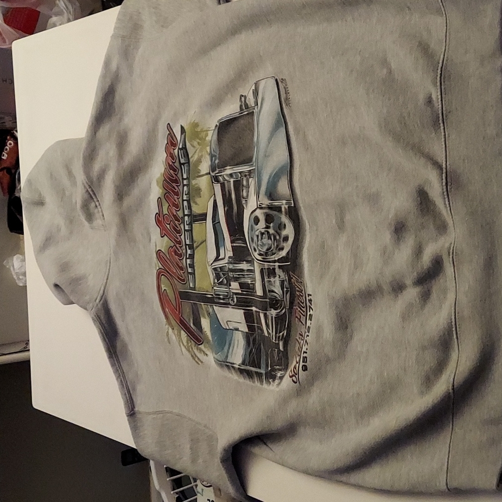 Grey hoodie with trucker logo, size L, 75% cotton/ 25% polyester with tag.
